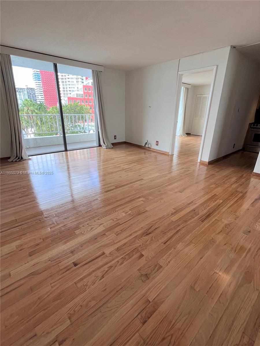 200 Southeast 15th Road, Unit 6A Miami, FL 33129 - Photo 2 of 14 an empty room with wooden floor and windows