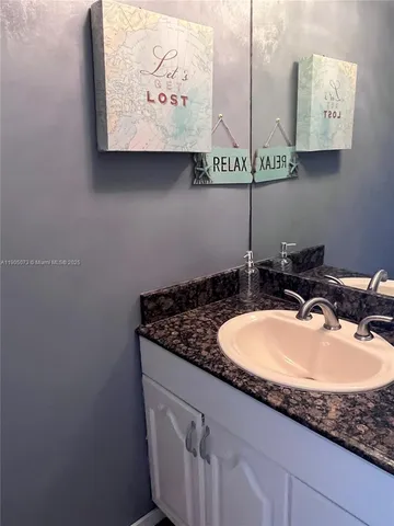 a bathroom with a sink and mirror
