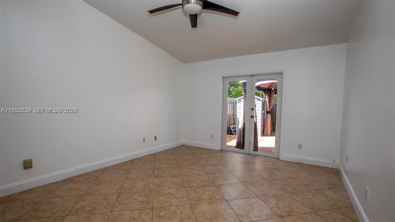 14206 Southwest 97th Terrace Miami, FL 33186 - Photo 11 of 33 an empty room with closet and a chandelier fan