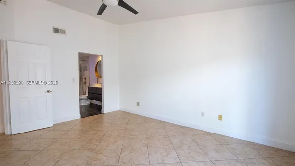 an empty room with closet and windows