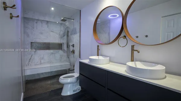 a bathroom with a toilet a sink and a mirror