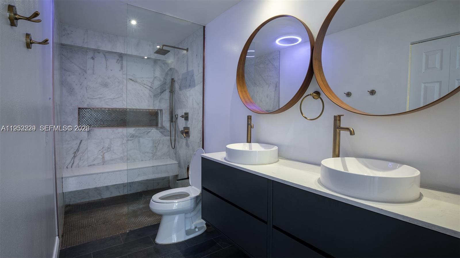 14206 Southwest 97th Terrace Miami, FL 33186 - Photo 16 of 33 a bathroom with a toilet a sink and a mirror