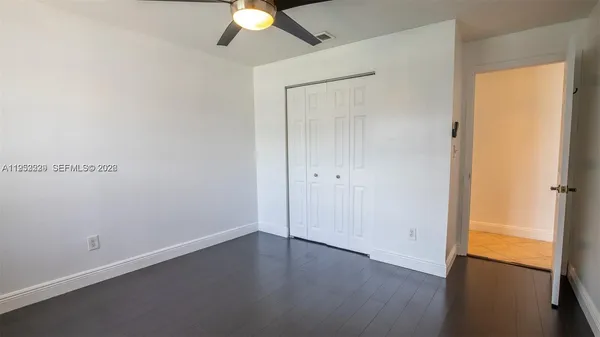 an empty room with a potted plant