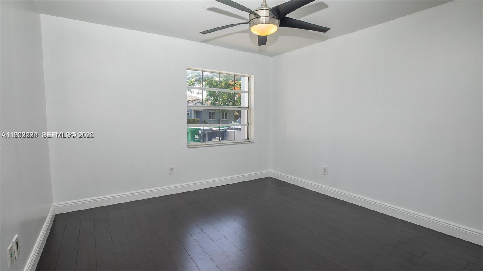 14206 Southwest 97th Terrace Miami, FL 33186 - Photo 19 of 33 an empty room with a window and a fan
