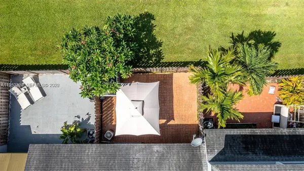 an outdoor view of the house and cars parked
