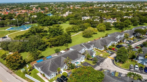 an aerial view of a house with a garden and swimming pool
