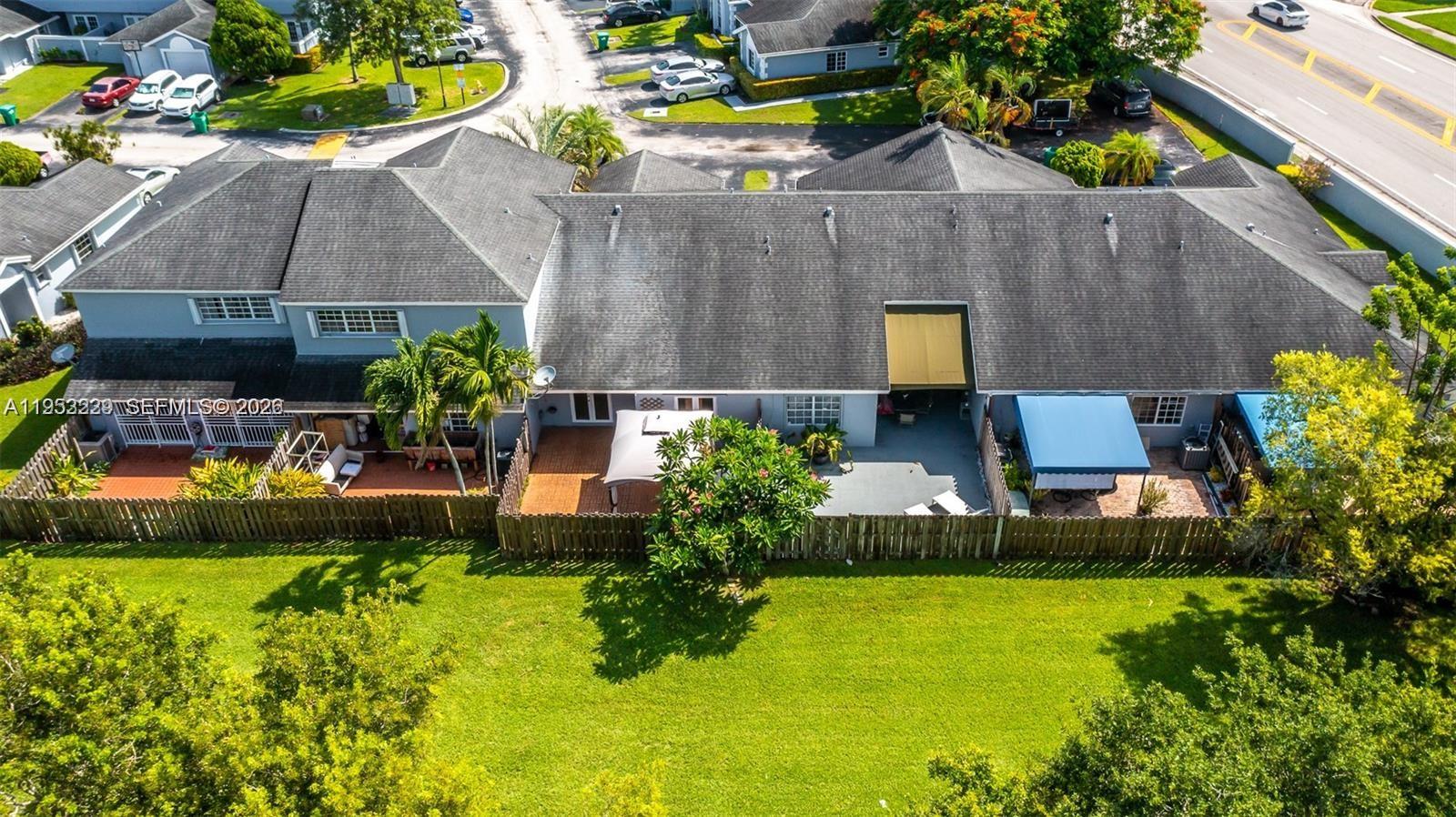 14206 Southwest 97th Terrace Miami, FL 33186 - Photo 28 of 33 a front view of house with yard and outdoor seating
