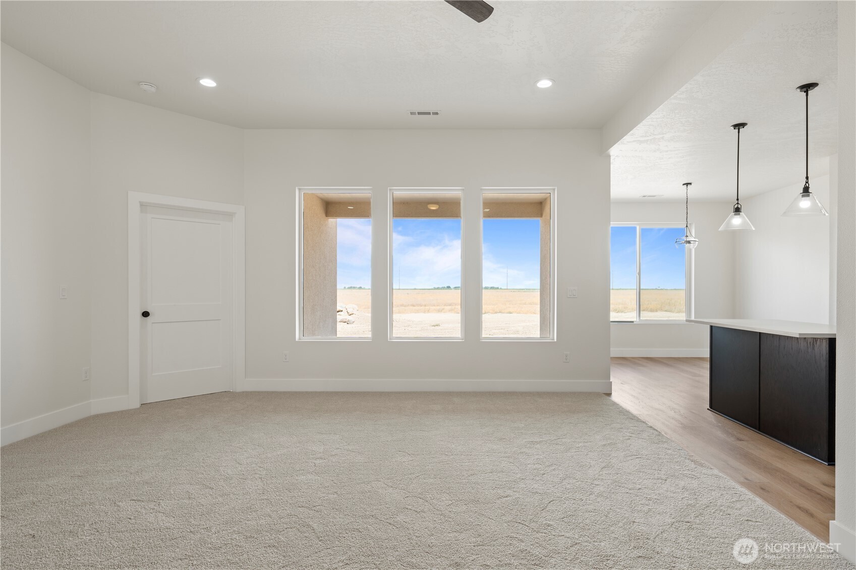 1111 E Mount Othello, WA 99344 - Photo 13 of 34 an empty room with wooden floor and windows