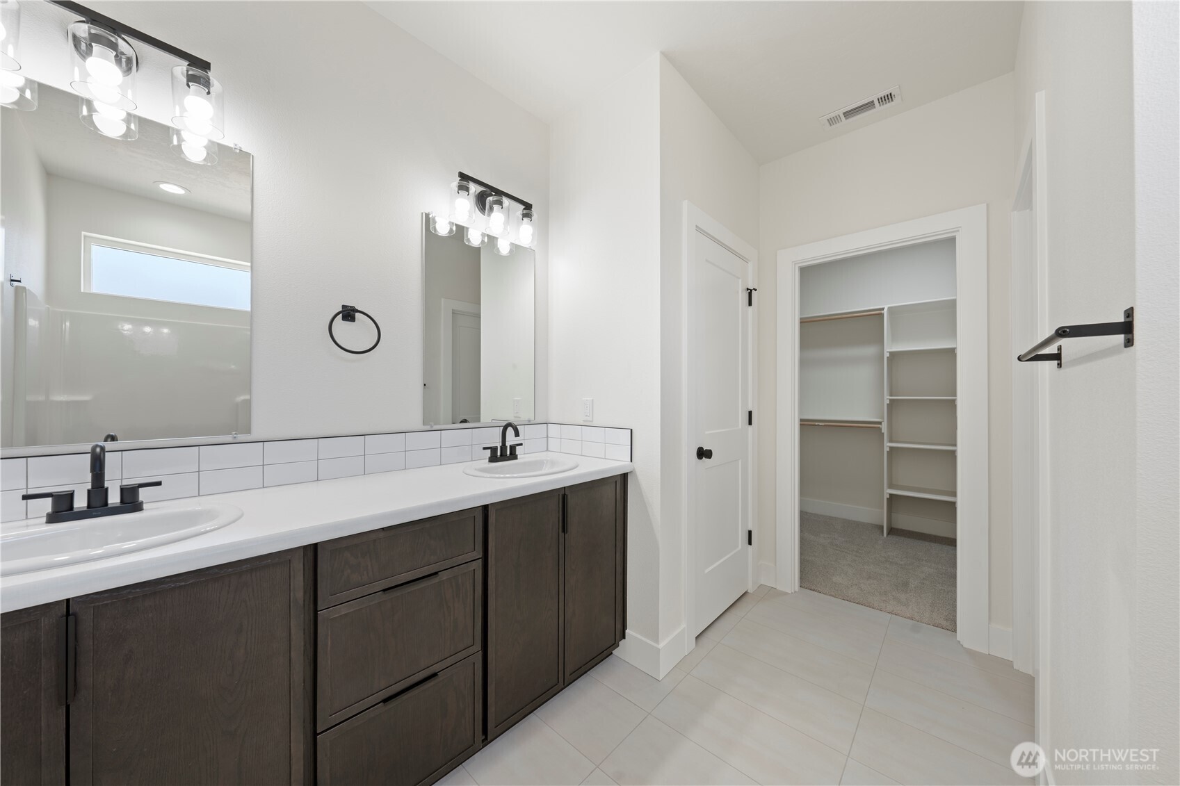 1111 E Mount Othello, WA 99344 - Photo 18 of 34 a bathroom with a double vanity sink mirror and shower