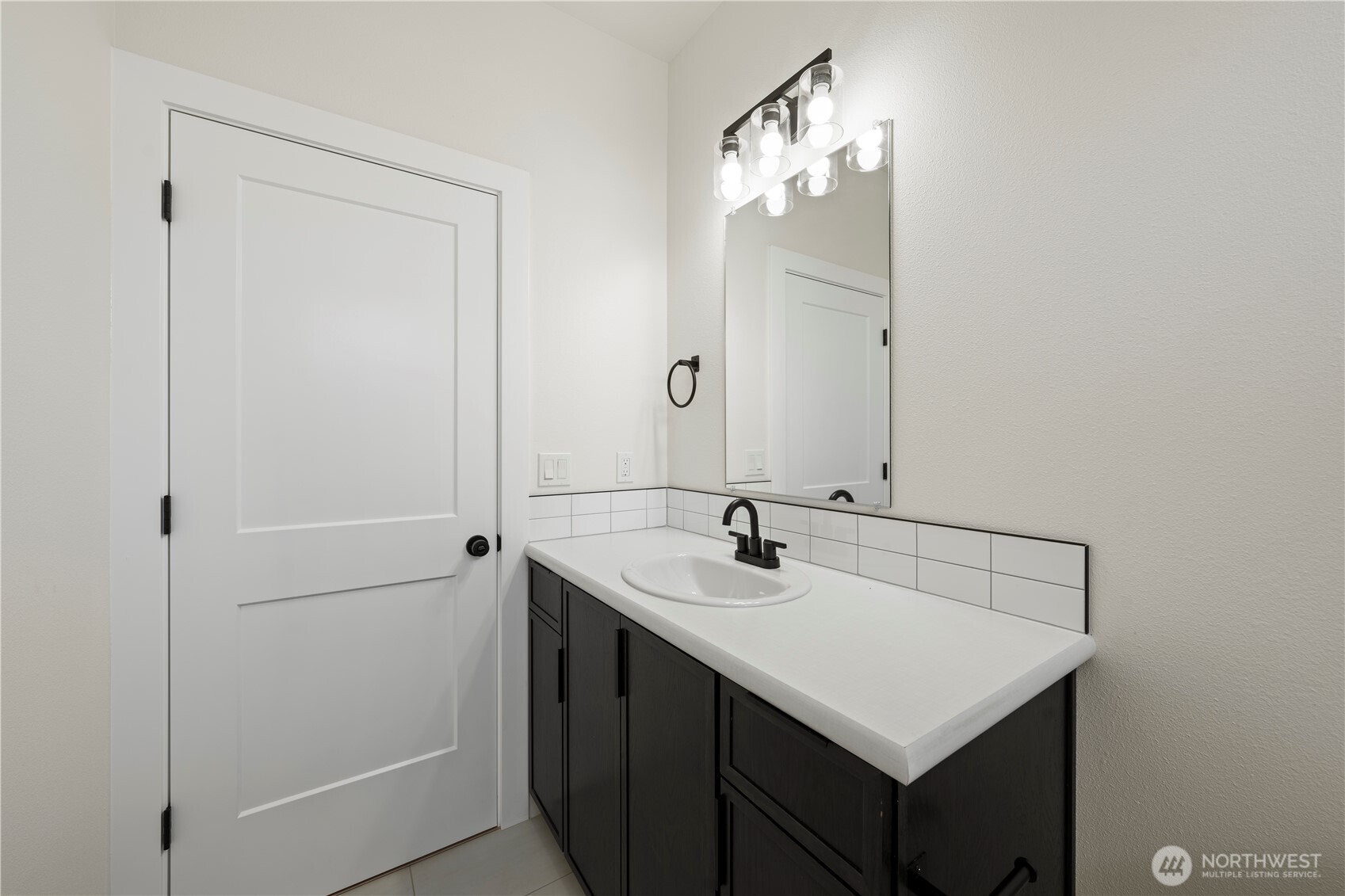 1111 E Mount Othello, WA 99344 - Photo 23 of 34 a bathroom with a sink vanity and a mirror