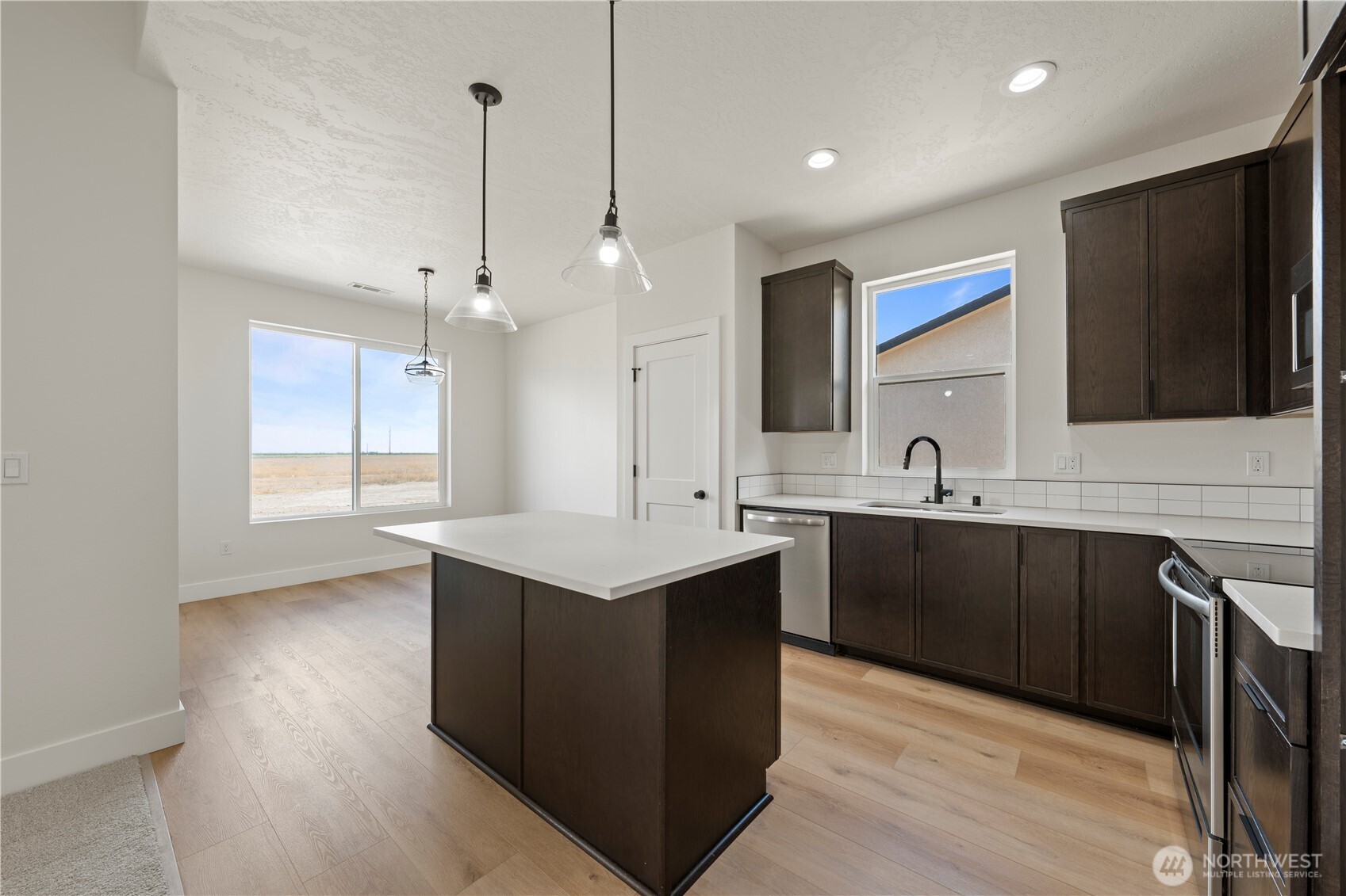 1111 E Mount Othello, WA 99344 - Photo 4 of 34 a kitchen with a sink cabinets and wooden floor