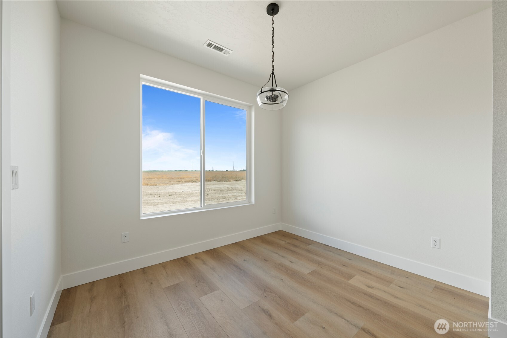 1111 E Mount Othello, WA 99344 - Photo 5 of 34 a view of a room with a window and wooden floor