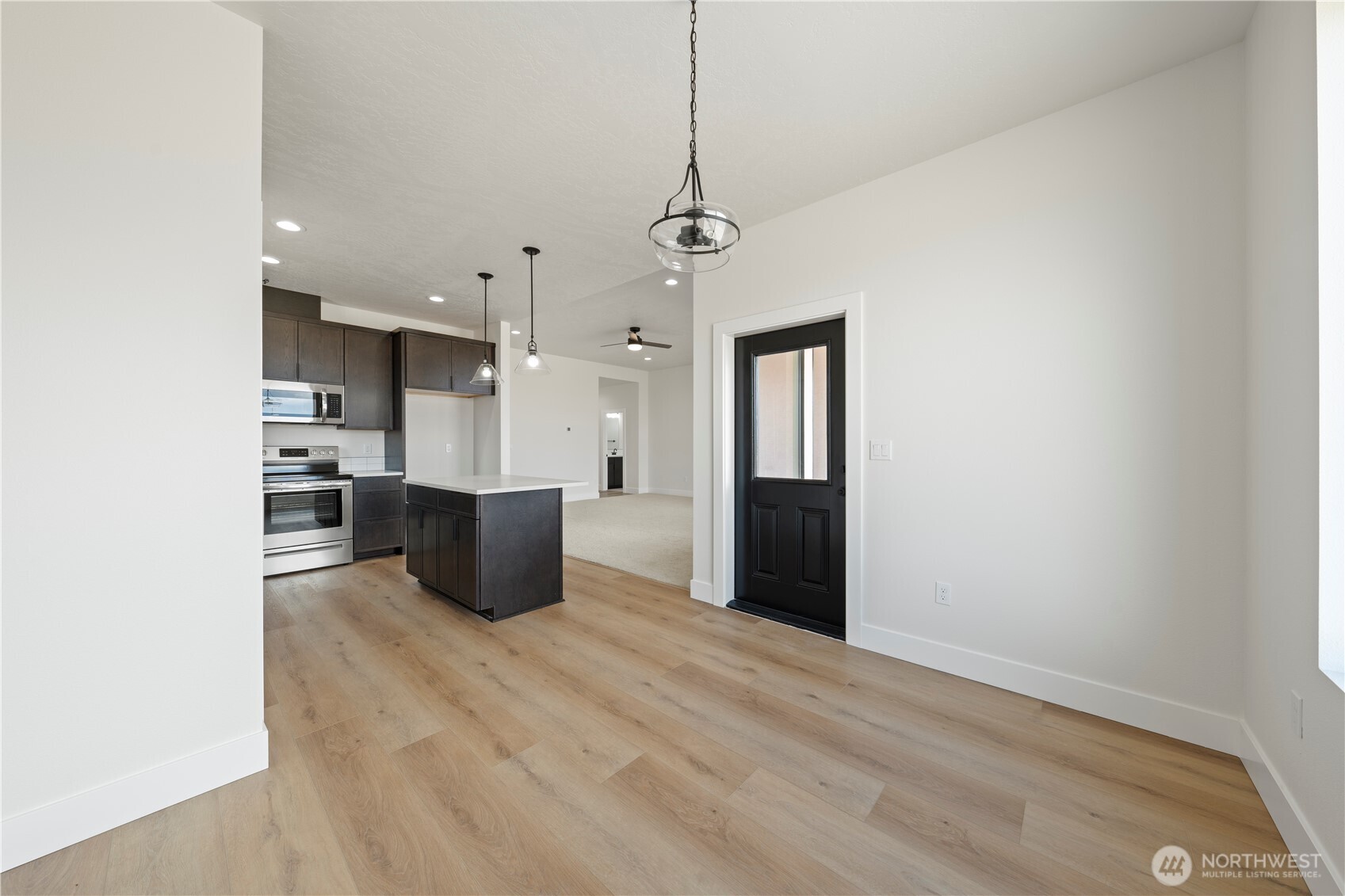 1111 E Mount Othello, WA 99344 - Photo 6 of 34 a kitchen with stainless steel appliances kitchen island wooden cabinets and granite counter tops