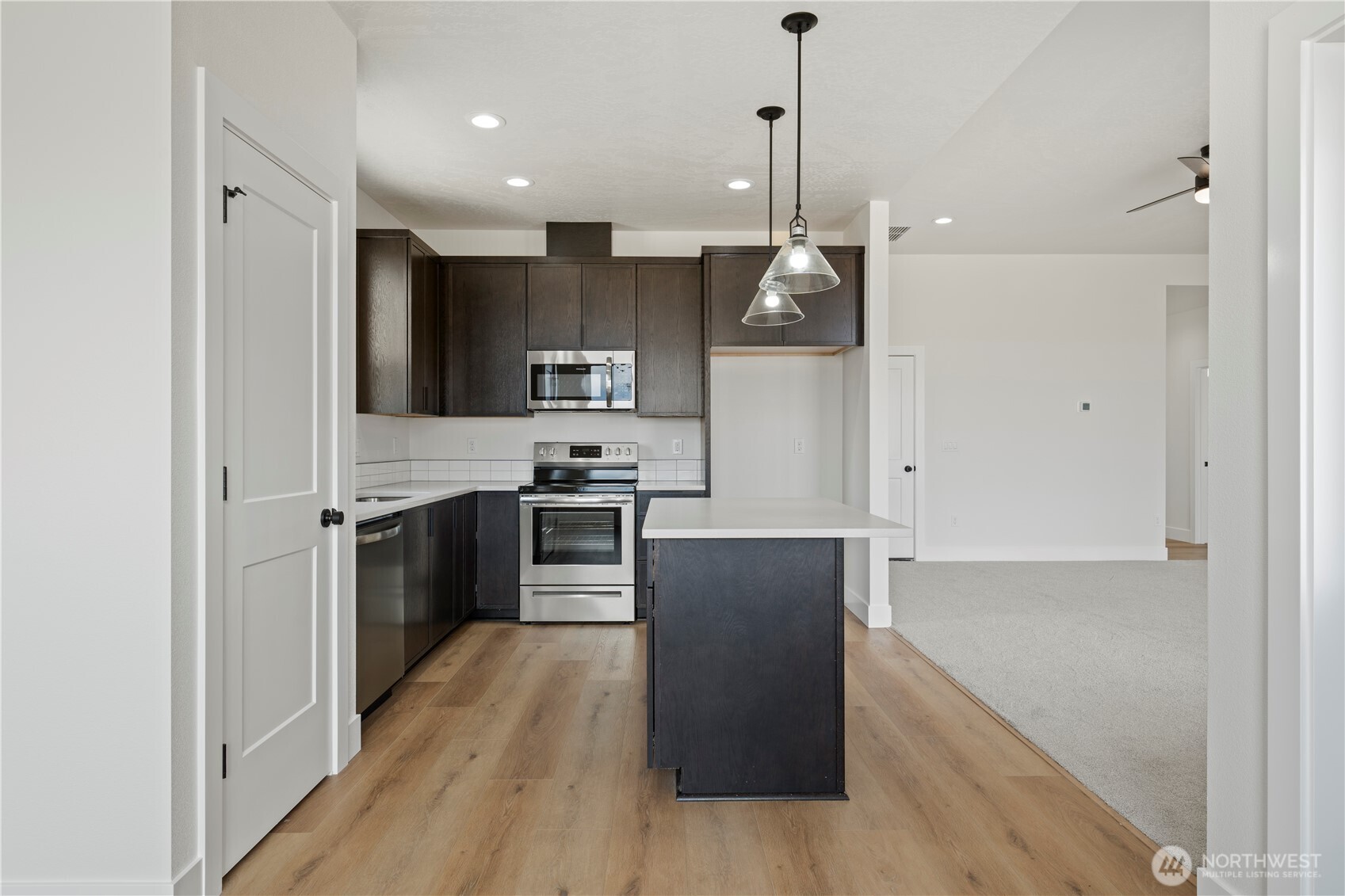 1111 E Mount Othello, WA 99344 - Photo 7 of 34 a kitchen with kitchen island a counter top space stainless steel appliances and cabinets