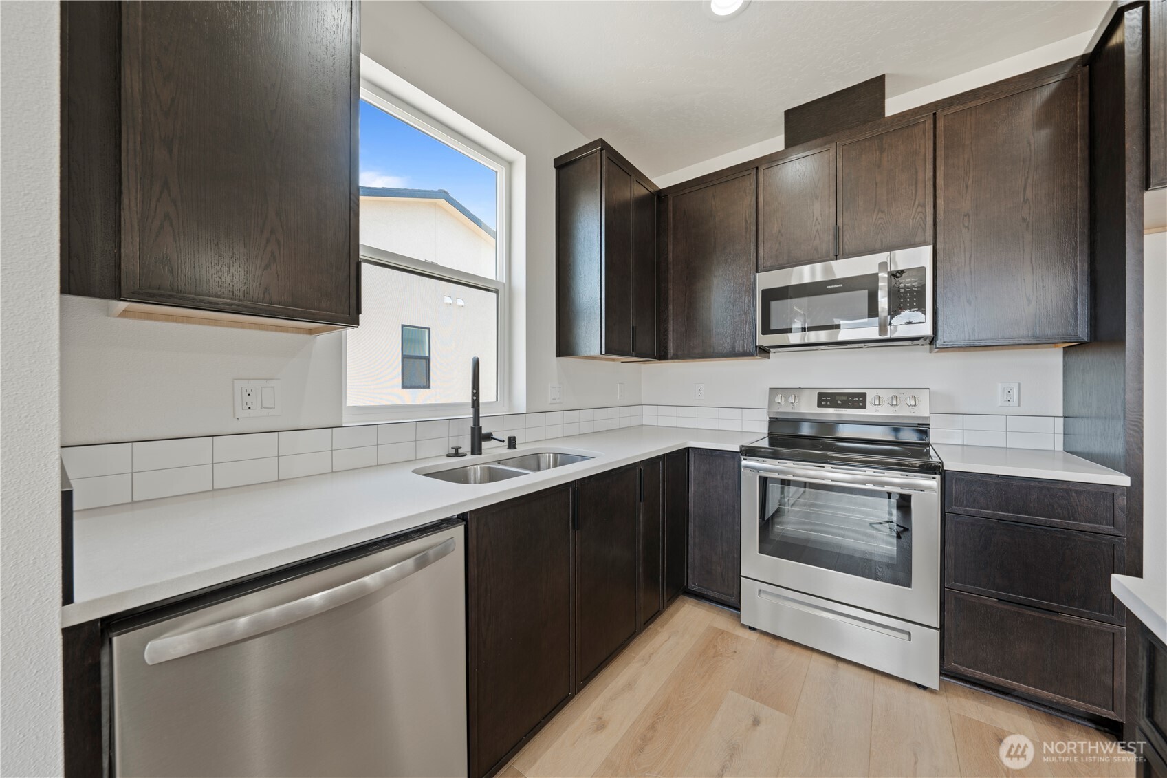 1111 E Mount Othello, WA 99344 - Photo 10 of 34 a kitchen with stainless steel appliances a sink stove and cabinets