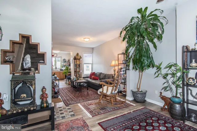 a living room with furniture and a potted plant
