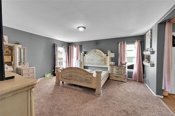 a spacious bedroom with a bed and a large window