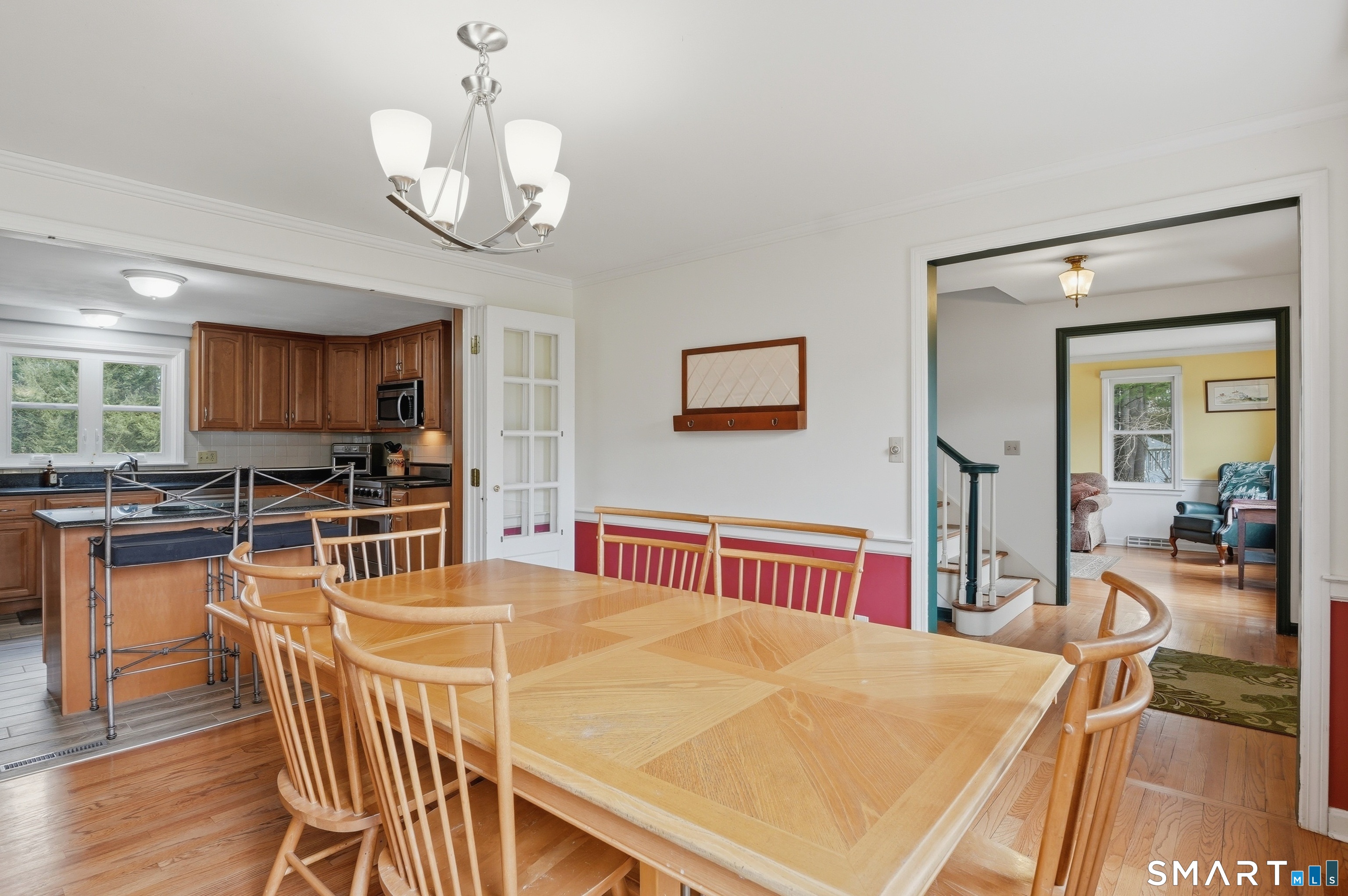88 Nob Hill Road Cheshire, CT 06410 - Photo 12 of 40 a view of a dining room with furniture a chandelier and wooden floor