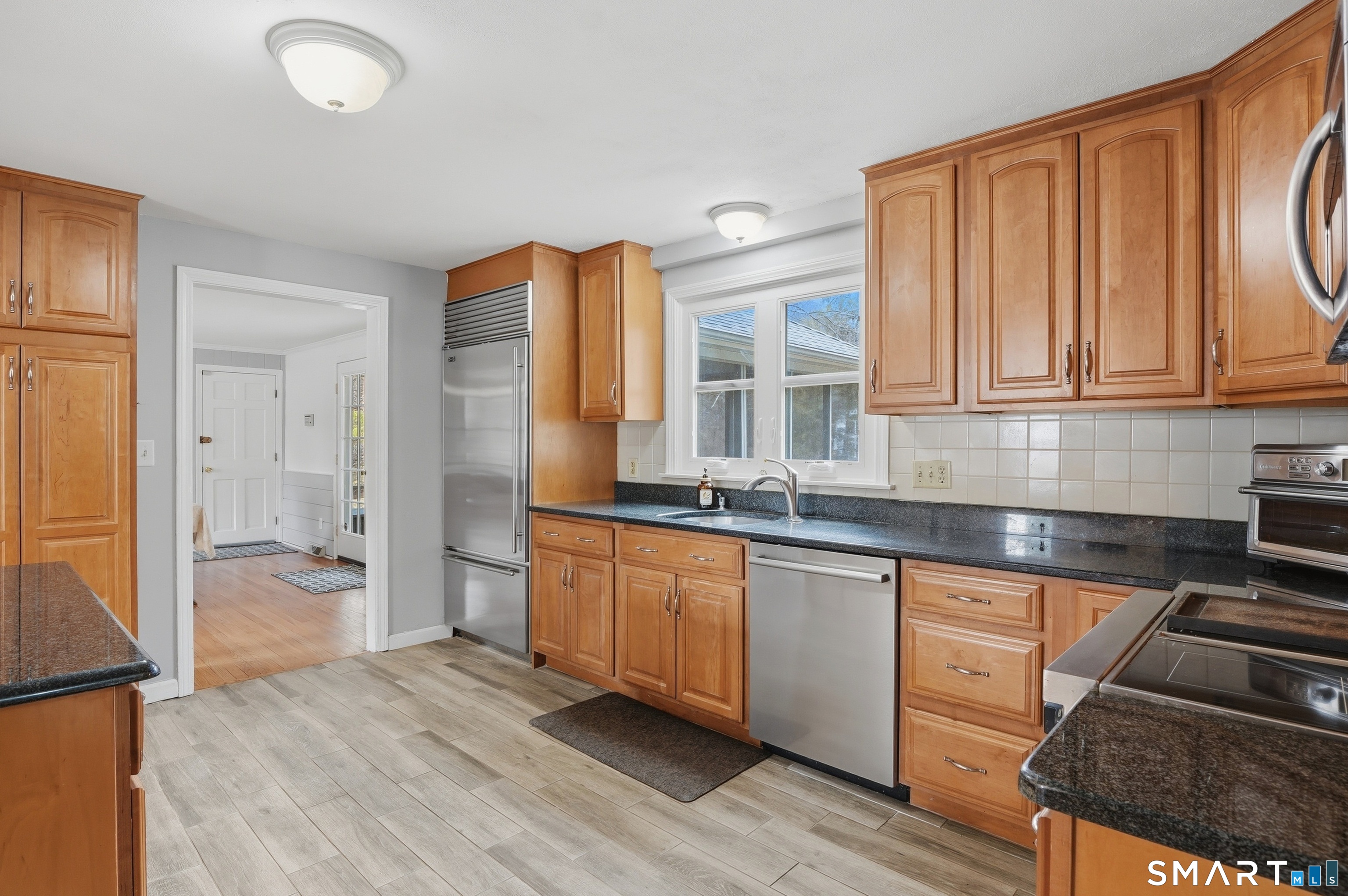 88 Nob Hill Road Cheshire, CT 06410 - Photo 15 of 40 a kitchen with stainless steel appliances granite countertop a stove a sink and a refrigerator with wooden cabinets