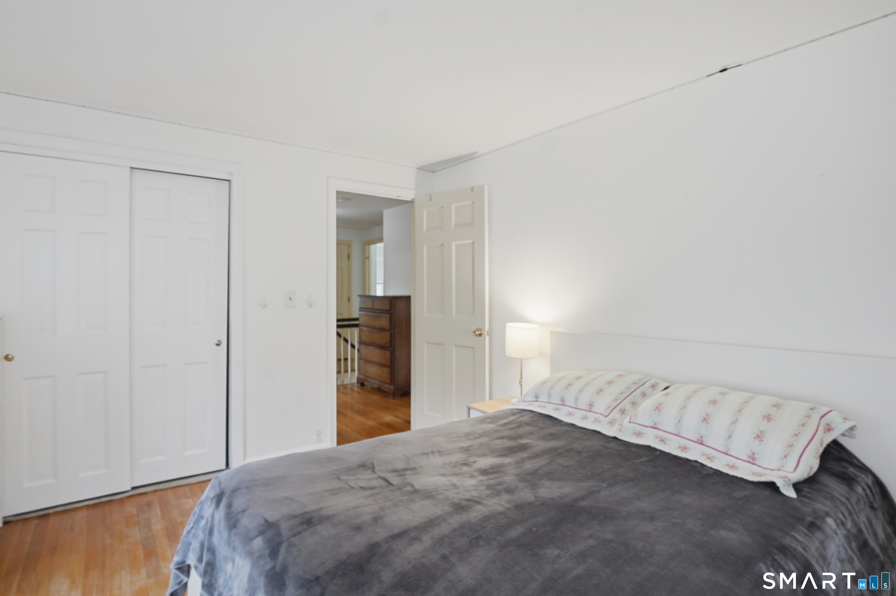 88 Nob Hill Road Cheshire, CT 06410 - Photo 30 of 40 a bedroom with a bed and a wooden floor
