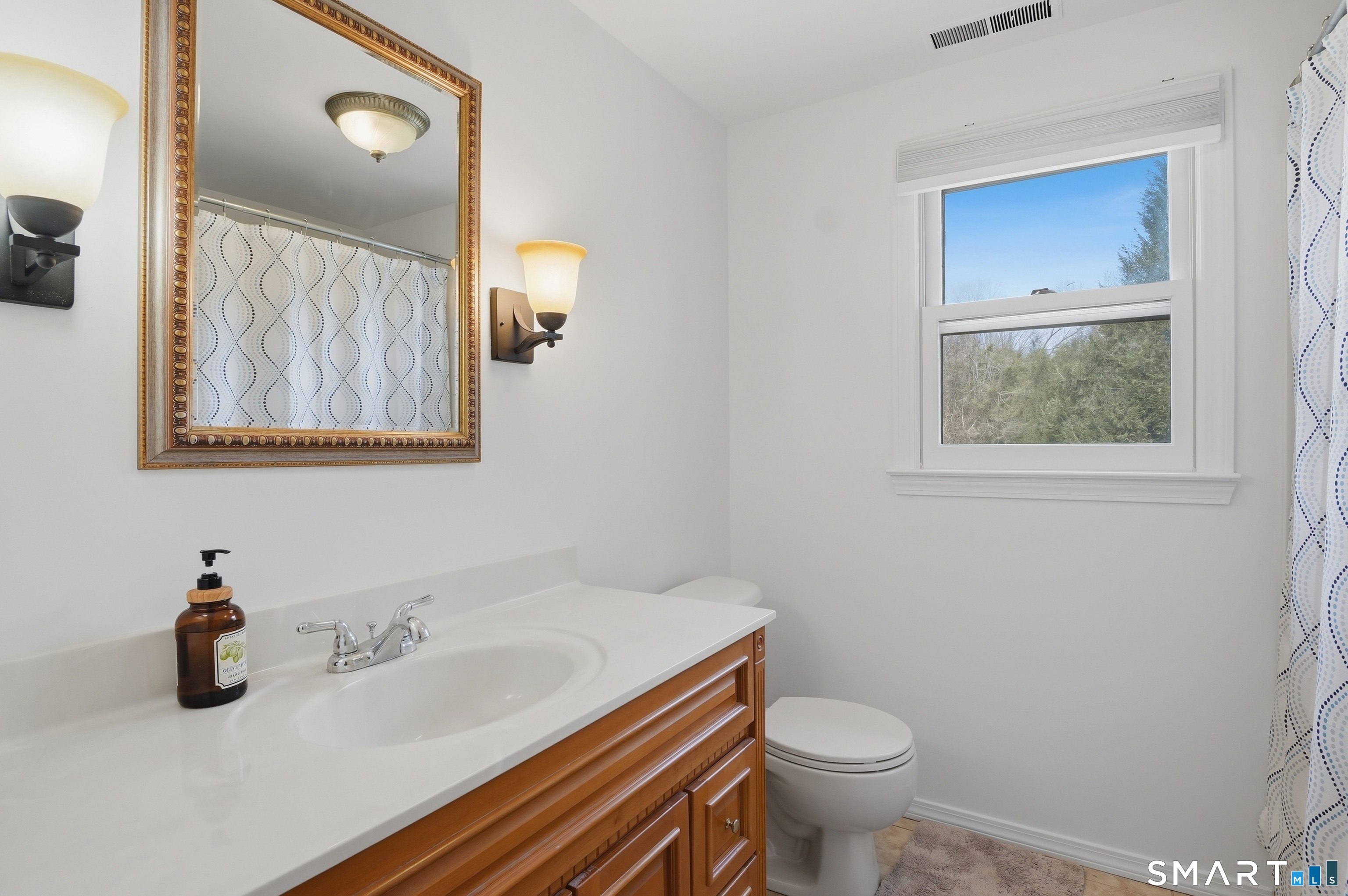 88 Nob Hill Road Cheshire, CT 06410 - Photo 31 of 40 a bathroom with a granite countertop sink a toilet and a mirror