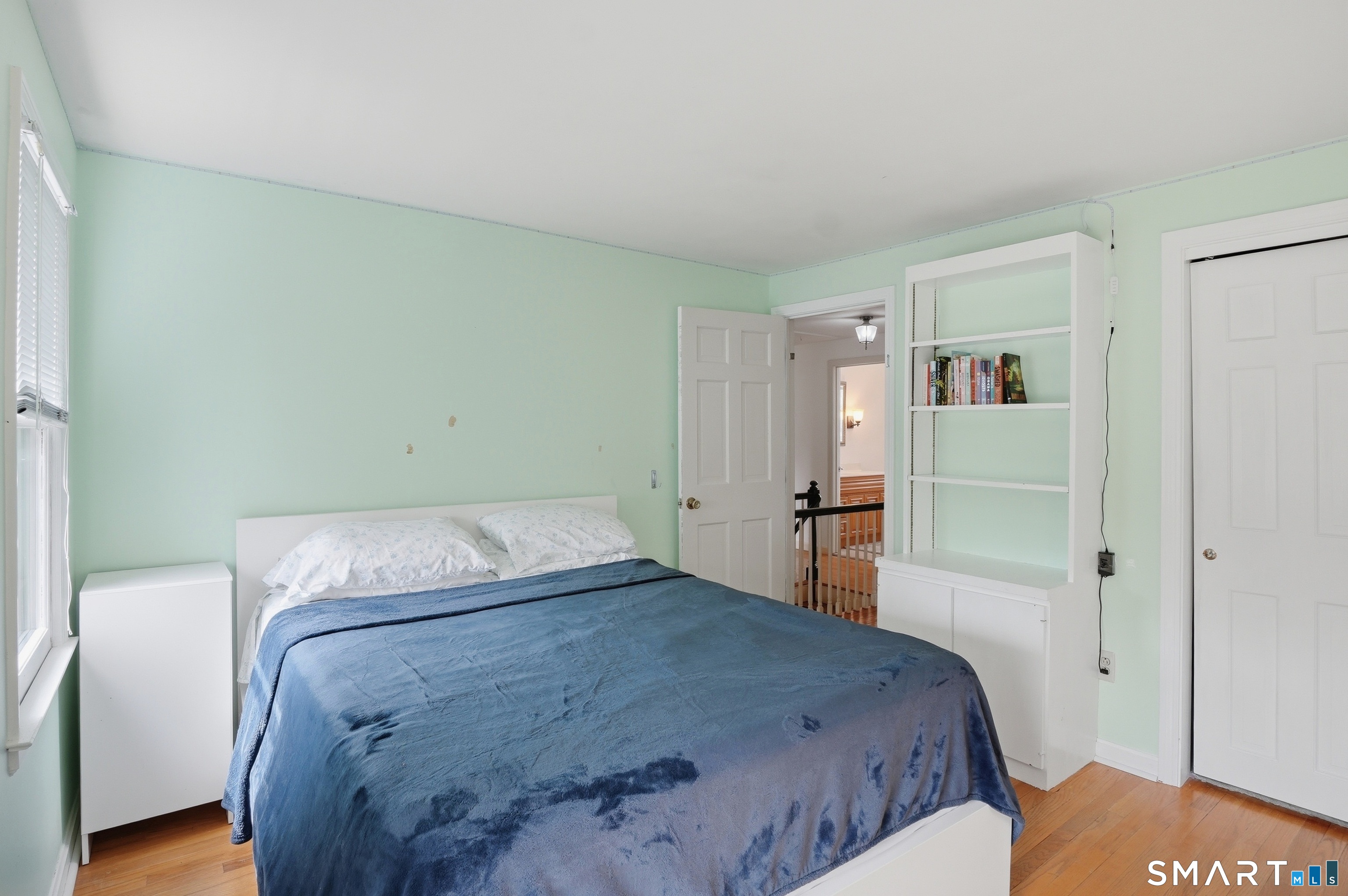 88 Nob Hill Road Cheshire, CT 06410 - Photo 36 of 40 a bedroom with a bed and wooden floor