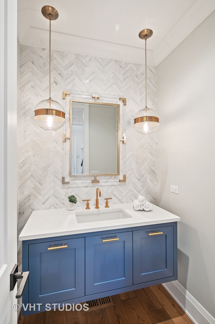 1025 Oak Street Winnetka, IL 60093 - Photo 14 of 38 a bathroom with a sink and a mirror