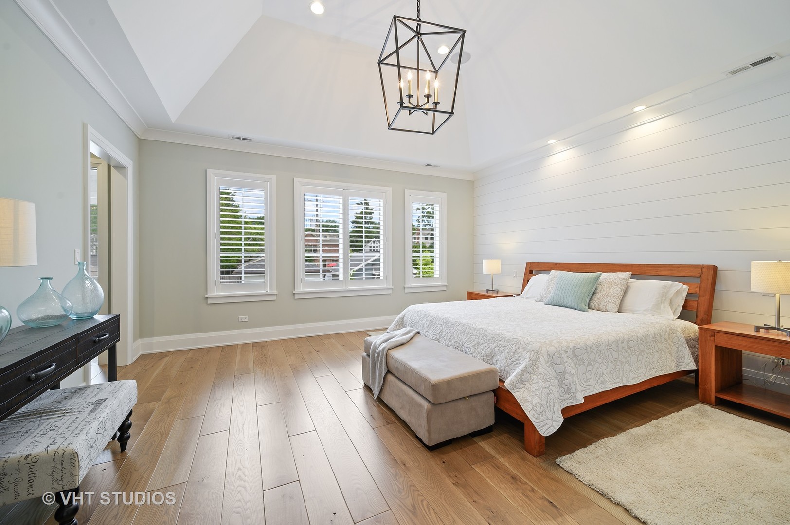 1025 Oak Street Winnetka, IL 60093 - Photo 16 of 38 a spacious bedroom with a bed a dresser and wooden floor