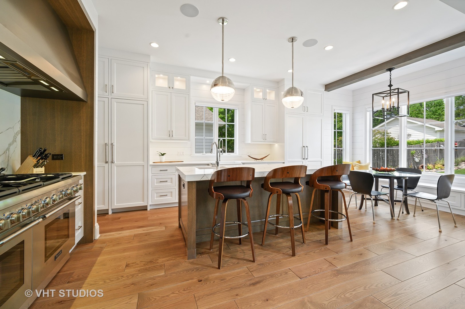 1025 Oak Street Winnetka, IL 60093 - Photo 7 of 38 a large kitchen with lots of furniture a sink appliances and a dining table