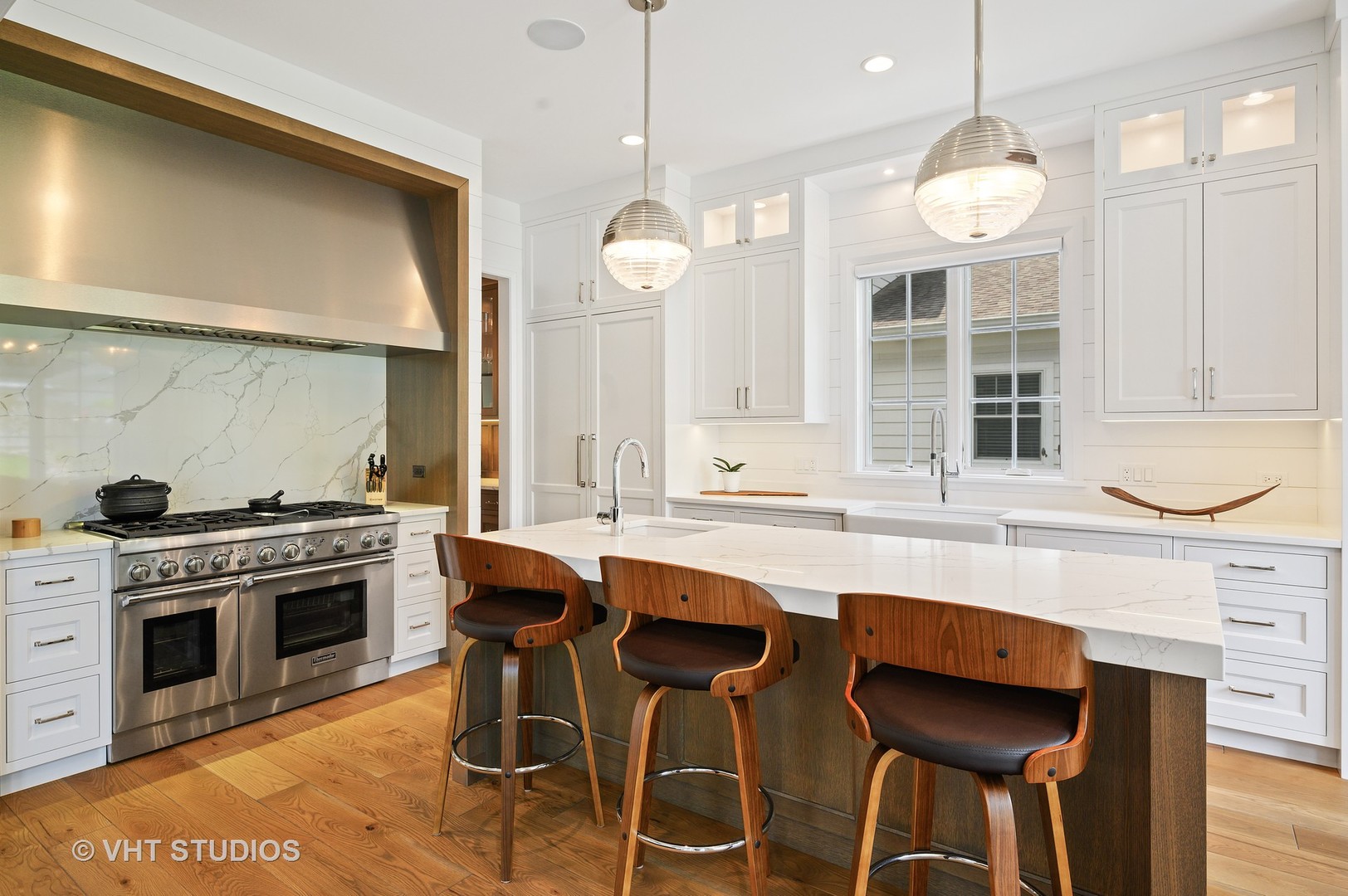 1025 Oak Street Winnetka, IL 60093 - Photo 8 of 38 a kitchen with stainless steel appliances a stove a sink and a refrigerator