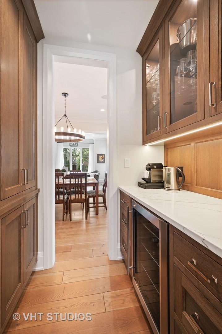 1025 Oak Street Winnetka, IL 60093 - Photo 9 of 38 a kitchen with cabinets and chairs