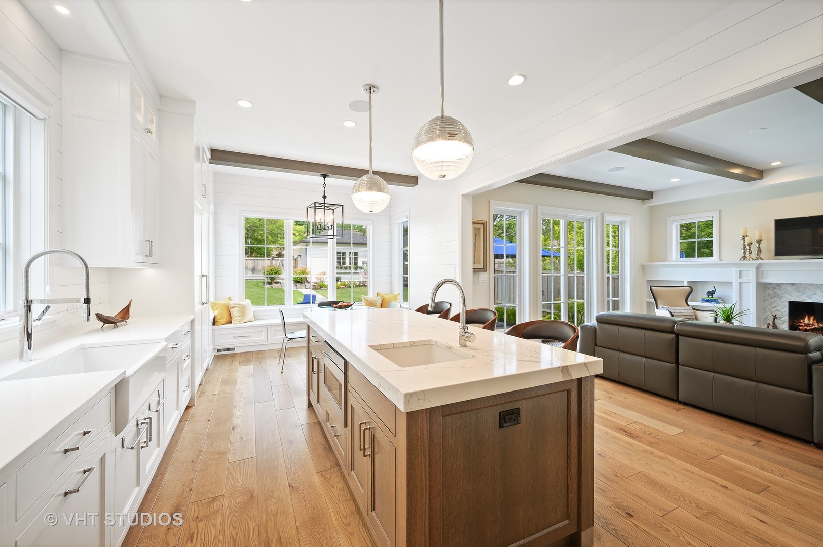 1025 Oak Street Winnetka, IL 60093 - Photo 10 of 38 a large white kitchen with a large window a sink and cabinets
