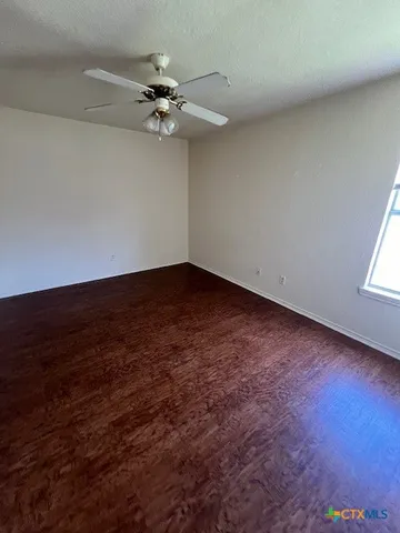 a bathroom with a granite countertop sink a toilet and bathtub