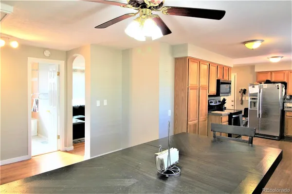 a view of kitchen with furniture and a ceiling fan