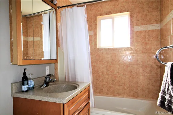 a bathroom with a sink a bath tub and a shower