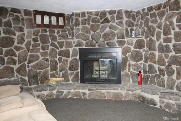 a living room with a fireplace and a walk in closet
