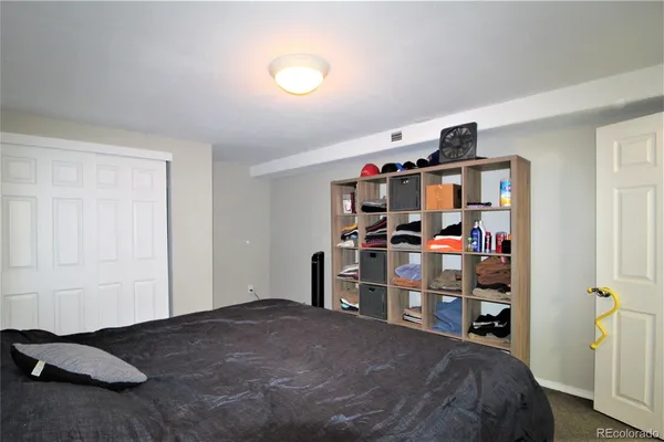 a bedroom with a bed and closet