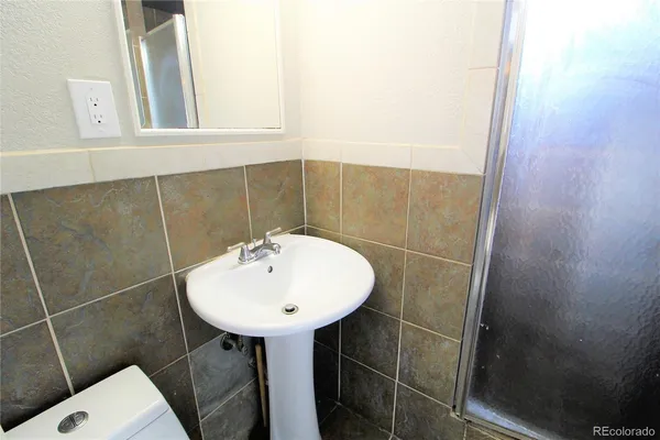 a bathroom with a sink a mirror and a window