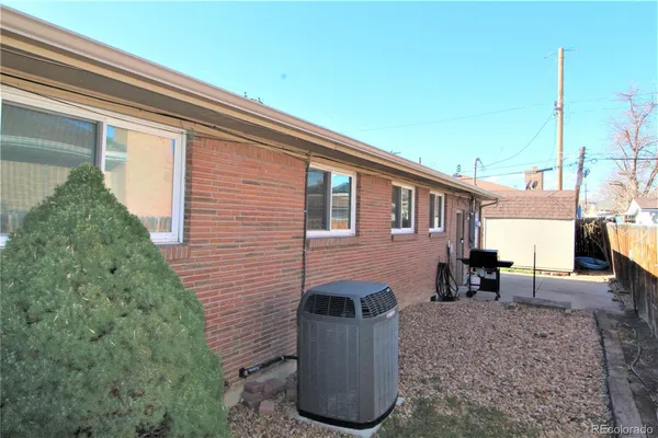 a view of backyard with barbeque grill and seating space