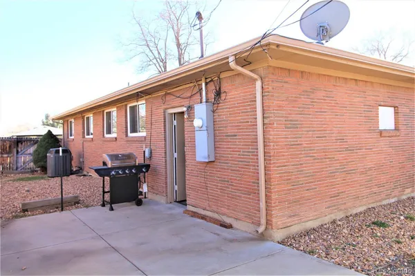 a backyard of a house with barbeque oven