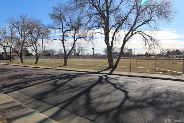 a view of a yard with wooden fence