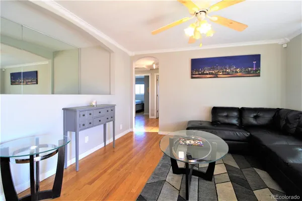 a living room with furniture and a wooden floor