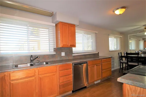 a kitchen with stainless steel appliances granite countertop sink stove and cabinets