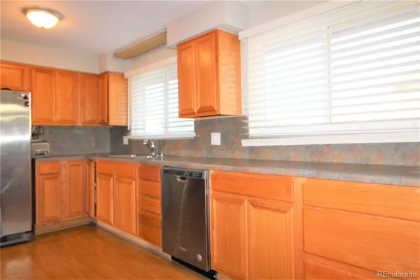 a kitchen with granite countertop sink cabinets and a large window