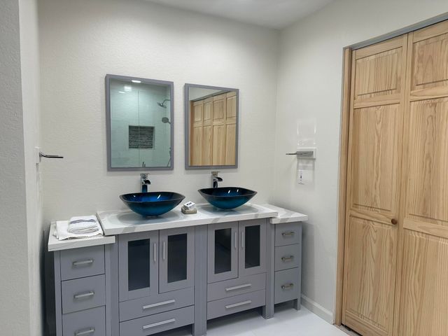 a bathroom with 2 sink and a mirror