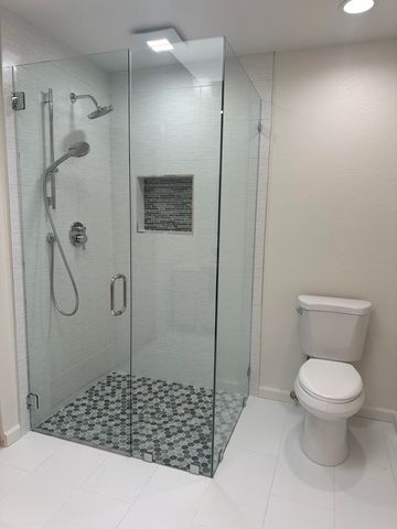 a bathroom with a shower and a toilet