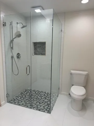 a bathroom with a shower and a toilet
