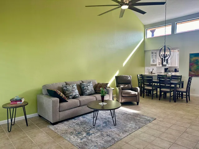 a living room with furniture and a piano