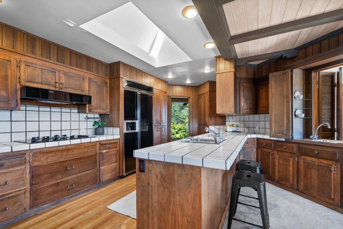 390 Rancho Soquel Drive Soquel, CA 95073 - Photo 37 of 97 a kitchen with stainless steel appliances kitchen island granite countertop a stove a sink and a refrigerator