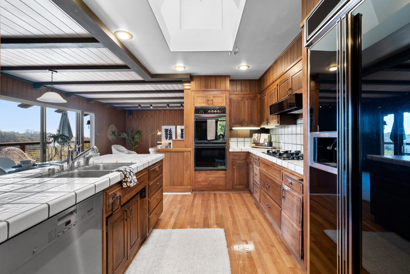 390 Rancho Soquel Drive Soquel, CA 95073 - Photo 40 of 97 a large kitchen with stainless steel appliances kitchen island granite countertop a large counter top a stove and a sink